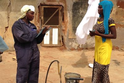 Female spray operator collecting household information