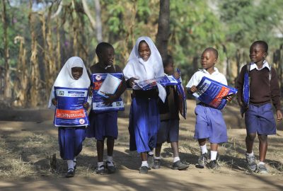 Children walk home after receiving bed nets at Iringo B primary school.