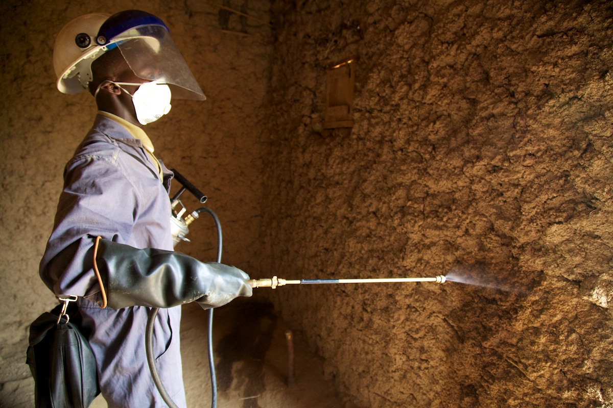 IRS spray operator conducting internal house spraying, IRS campaign, Rwanda, 2014